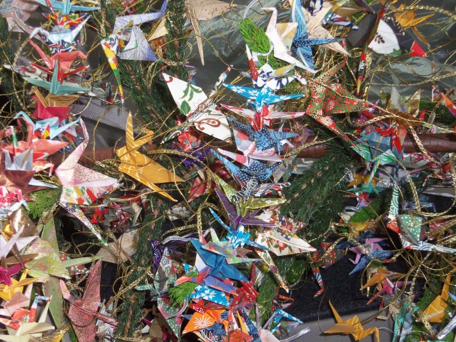 Our friend Carolyn has made Yule trees that are essentially all origami figures. Some have been white while others, like the strands shown from this one, are multicolored. The cranes, of course, are prayers for peace. 