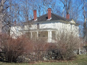 The mansion has four chimneys, rather than one, plus a porch looking toward the river.