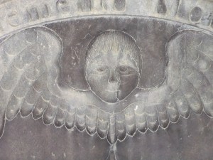 The winged death's head is a common gravestone motif in New England. This example is in Watertown, Massachusetts.