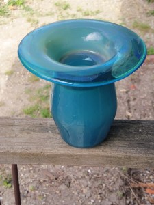 A blown-glass vase created by an art student. We saved clear beer bottles for the cause.