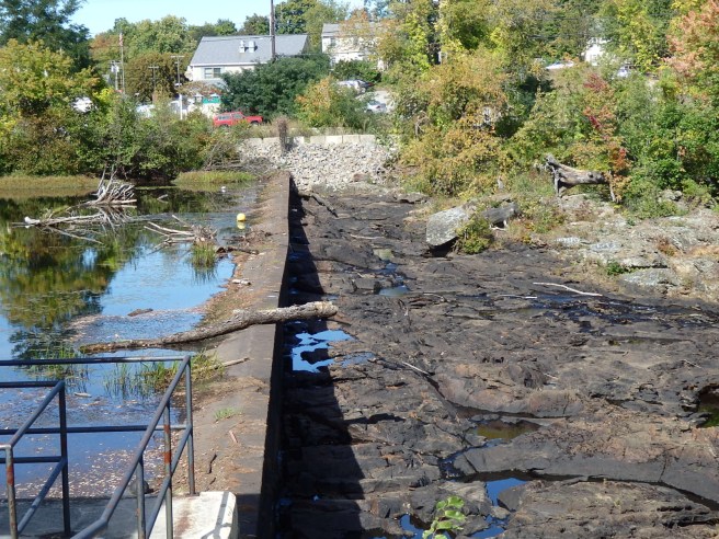 A dam atop the Great Falls connects Somersworth, New Hampshire, to Berwick, Maine. Last year's drought exposes both sides of the river.